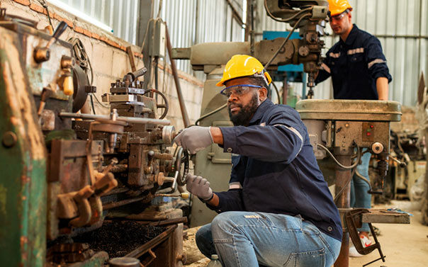 factory workers wearing safety uniform checking system of the welding machine